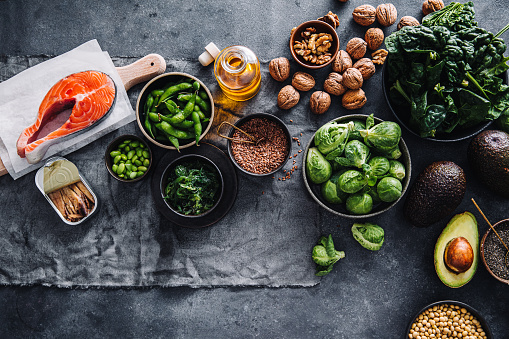 Table top view of a healthy food ingredients on table. Omega 3 and healthy fats rich food items on kitchen counter.