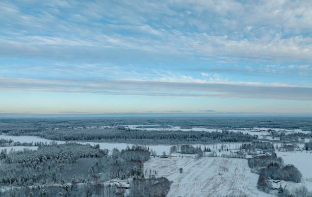 The village of Skare surrounded by snowy forest landscape in the city of Karlstad, Varmland, Sweden, seen a cold winter afternoon.