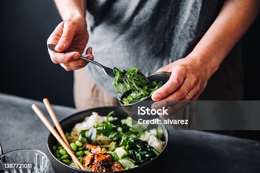 istock Close-up of woman eating omega 3 rich salad 1387721011