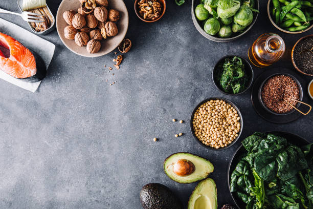 Top view of healthy omega 3 rich food ingredients Top view of vegetables with salmon steak and canned sardine over the slate background. Top view of healthy omega 3 rich food ingredients. fish in a bowl stock pictures, royalty-free photos & images