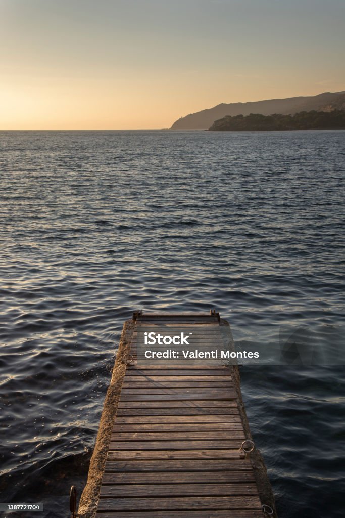 Pier in Cadaques town A wooden pier over the water in Mediterranean Sea in Sunrise in Cadaques town in Catalonia Cadaques Stock Photo