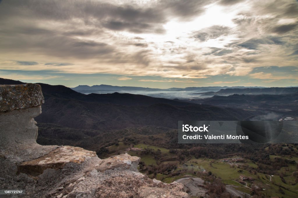 Misty landscape in Santa Maria de Besora Misty landscape showing a valley and some mountains under a cloudy sky in Santa Maria de Besora in Catalonia Color Image Stock Photo