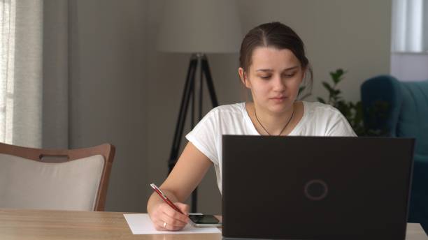 istock Authentic Stressful Woman working Chatting On Laptop Living Room. Writing Searching Using IT. Tired Sad Lady Working On Computer Internet On Comfortale Chair. Buisenes, Education, Technology Concept 1387725152