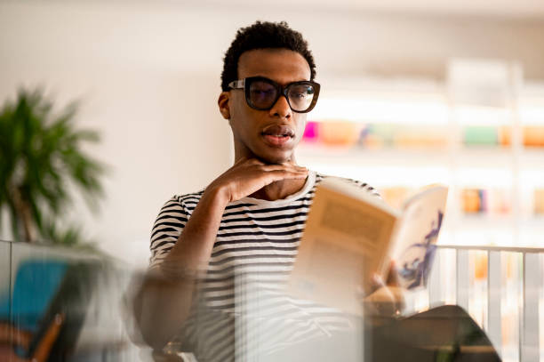 istock Book club member reading a book 1387726059