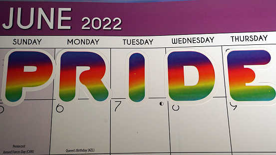 Pride month marked on the calendar in June with rainbow letter stickers.
