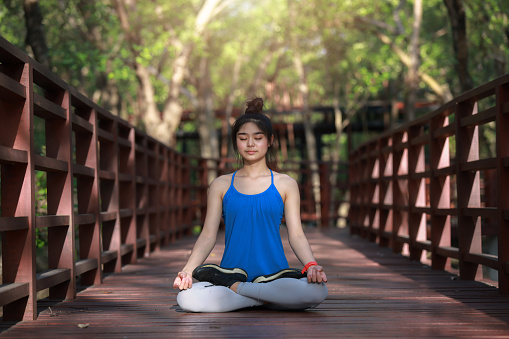 Young Healthy girl exercise the Yoga with Mediation , Morning Meditation