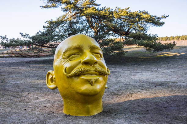 Yellow funny human head sculpture, Birstonas, Lithuania.