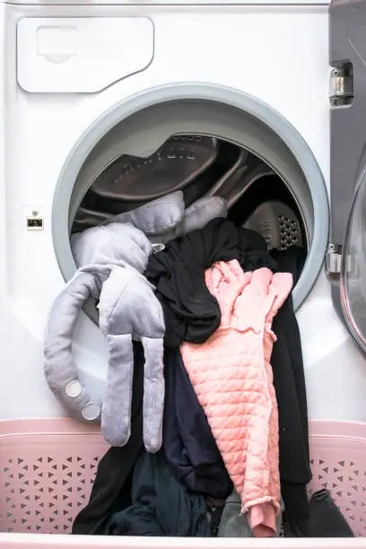 Photo of washed clean laundry taken out of the washing machine