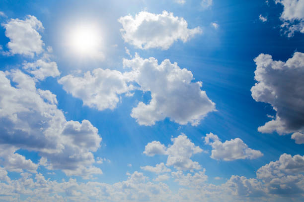 istock The bright sky was covered with white clouds, illuminated by the sun's rays. 1387730147