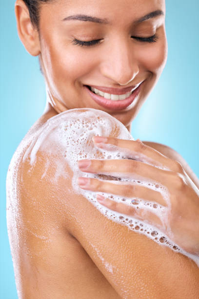 Cropped shot of a woman using a body wash on her skin I love a body wash that bubbles up instantly shower gel stock pictures, royalty-free photos & images