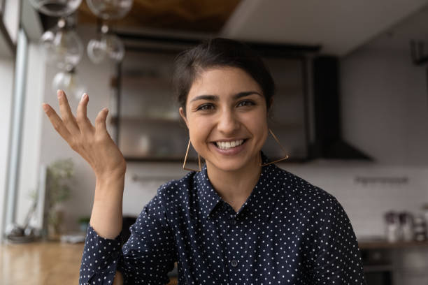 istock Happy Indian woman holding video call conversation. 1387743653