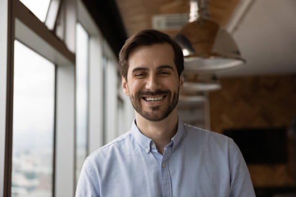 istock Happy candid young caucasian man looking at camera. 1387743658