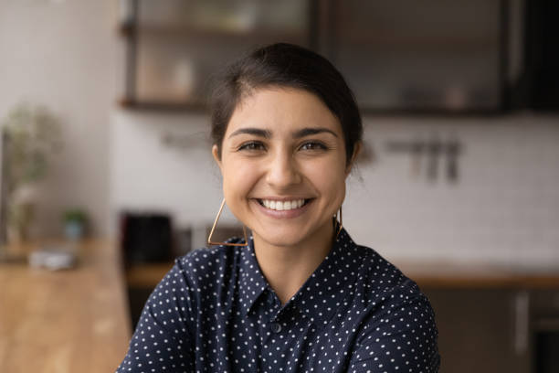 istock Smiling young Indian woman enjoying video call conversation. 1387743677