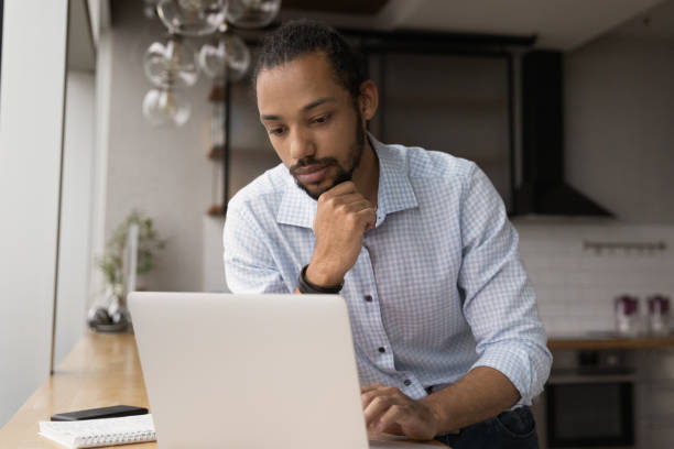 istock Pensive young African American businessman thinking of problem. 1387743690