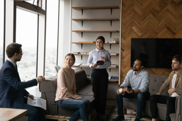 istock Happy young motivated colleagues discussing ideas in office. 1387743705