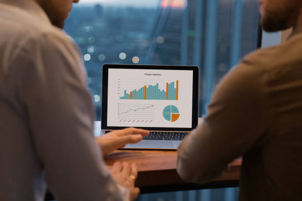 istock Close up focus on laptop screen with project statistics. 1387743726