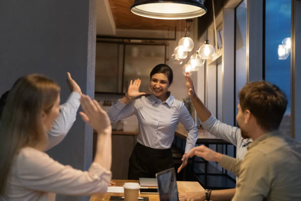 istock Happy Indian leader giving high five to colleagues. 1387743737