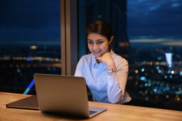 istock Smiling motivated young Indian businesswoman working on computer. 1387743744
