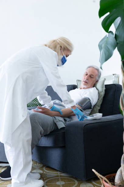 istock Female Doctor Visiting A Patient At Home 1387750086
