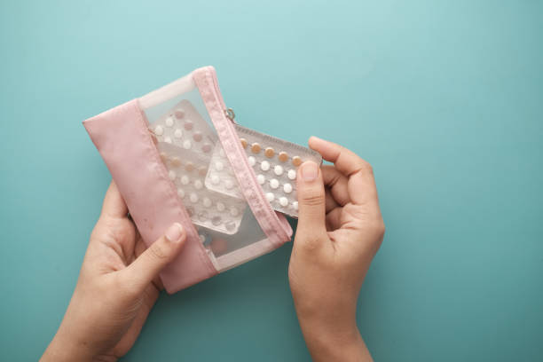istock women hand holding birth control pills close up 1387750129