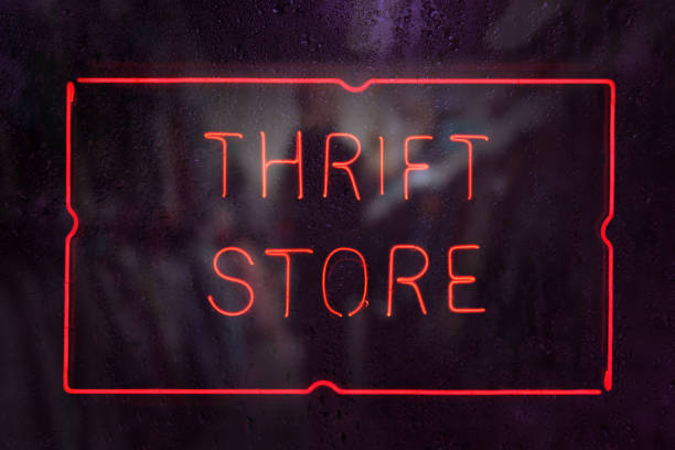 Vintage Neon Thrift Store Sign in Rainy Store Window