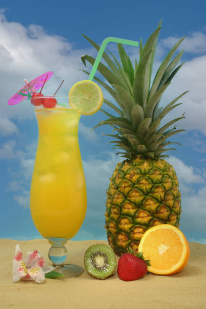 istock Pineapple, Tropical Drink and Fruit on Sand With Sky 1387753063