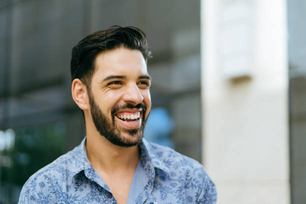 istock Smiling businessman in the city 1387753755