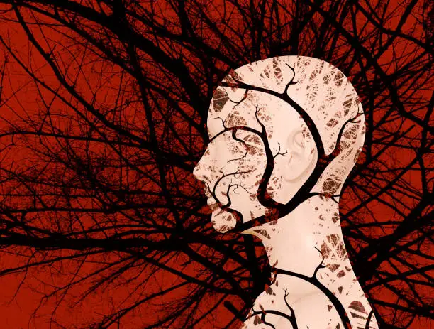 Artwork illustration of female head silhoette with black tree and branches in double exposure effect, psychology and mental health concept.