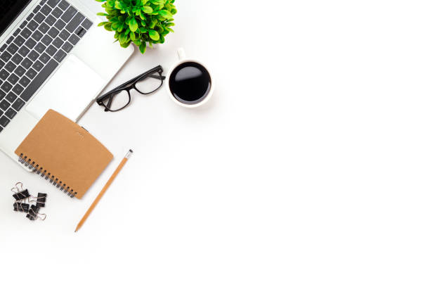 istock White office desk table with blank notebook, computer keyboard and other office supplies. Top view with copy space, flat lay. 1387759697
