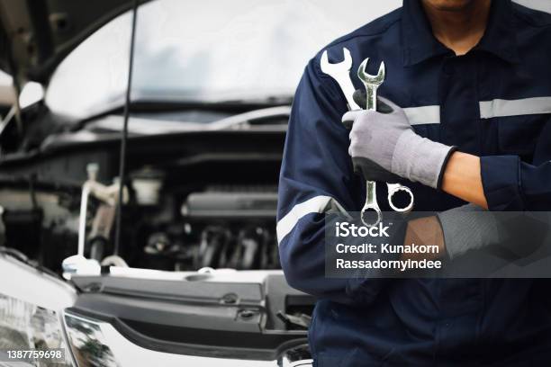 Hand Of Car Mechanic With Wrench Auto Repair Garage Mechanic Works On The Engine Of The Car In The Garage Repair Service Concept Of Car Inspection Service And Car Repair Service Stock Photo - Download Image Now