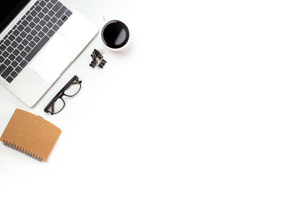 istock White office desk table with blank notebook, computer keyboard and other office supplies. Top view with copy space, flat lay. 1387759699