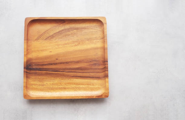 istock Empty wooden plate on gray cement table background, banner with copy space, Blank wood tray for food display montage, template, mock up, top view, flat lay 1387764180