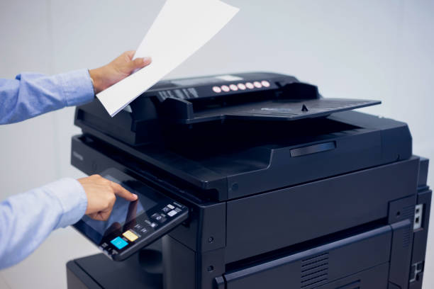 istock Bussiness man Hand press button on panel of printer, printer scanner laser in office copy machine supplies start concept. 1387764400