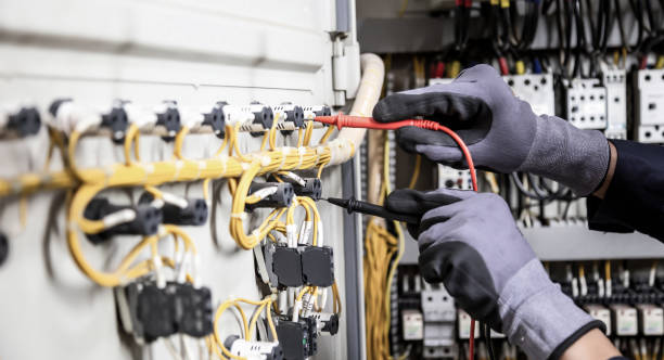 istock Electrician engineer tests electrical installations and wires on relay protection system. Adjustment of scheme of automation and control of electrical equipment. 1387764505
