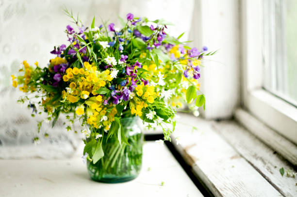 beautiful fresh spring bouquet flowers herbs on table. happy mothers day, floral card. wild forest flowers bouquet - blommande växt bildbanksfoton och bilder