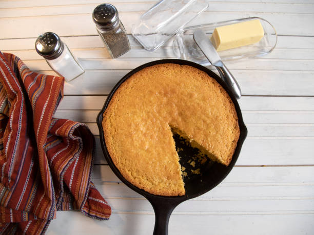 istock Cornbread in cast-iron skillet top view on white wood table 1387767297