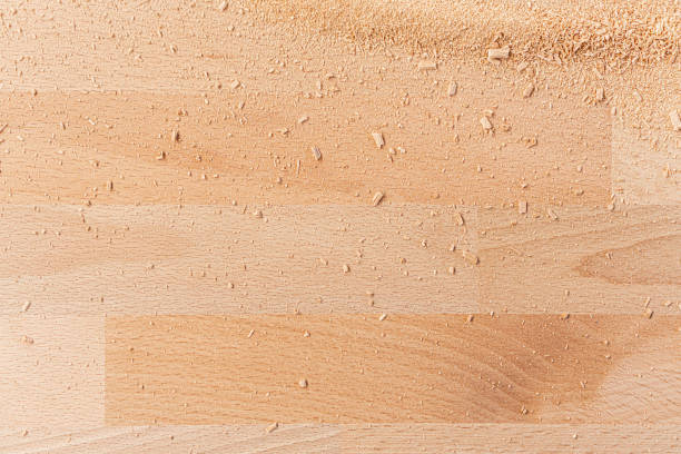 background of wooden board with scattered sawdust - sawdust imagens e fotografias de stock