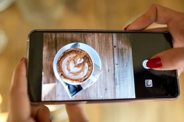 istock Blogger photographing coffee 1387770340