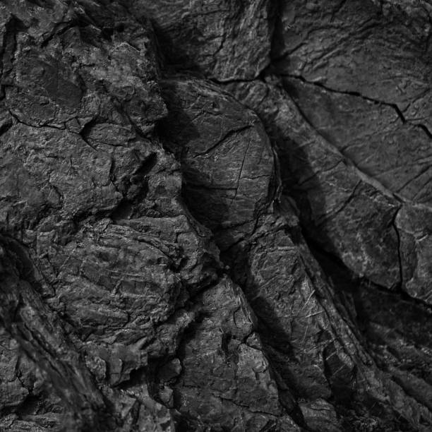 istock Black white rock texture. Cracked mountain surface. Close-up. Dark gray stone grunge background. 1387770450