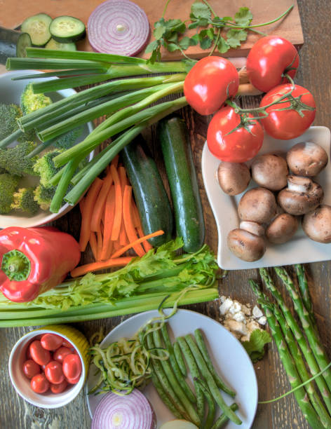 istock Top view of assorted freshly cut vegetables on natural wood surface 1387770540