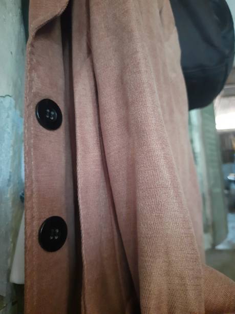 istock brown jacket with two big black buttons 1387773422