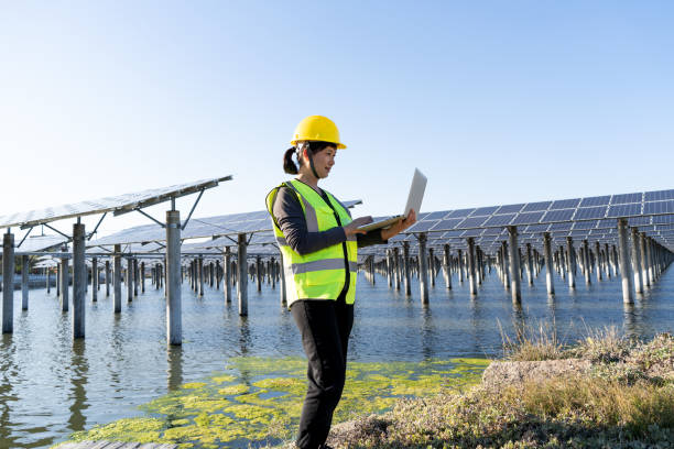 istock Female engineer at solar power plant using laptop 1387775217