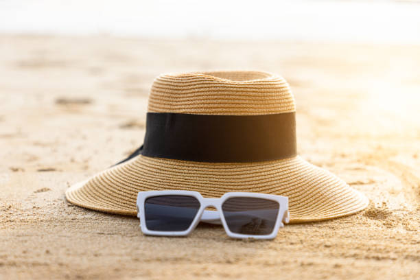 istock Beautiful beach with sunglasses and hat on the beach. 1387776085