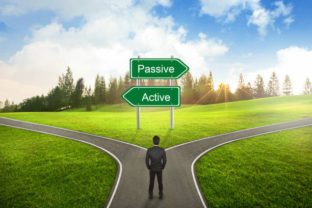 istock Businessman concept, Businessman standing between Active or Passive sign road to the correct way. 1387777548