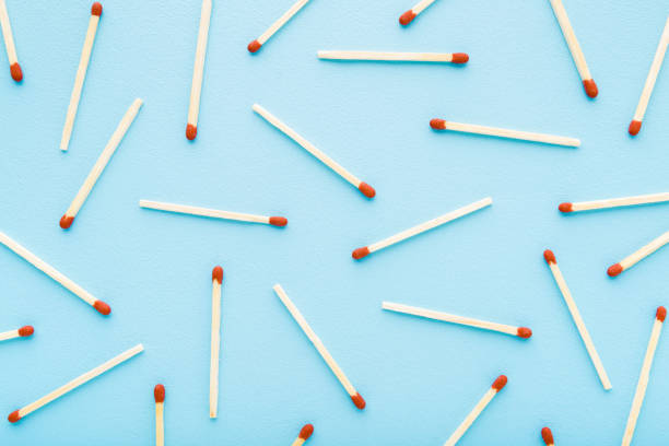 Match sticks on light blue table. Pastel color. Pattern background. Closeup. Top down view. Match sticks on light blue table. Pastel color. Pattern background. Closeup. Top down view. unlit match stock pictures, royalty-free photos & images