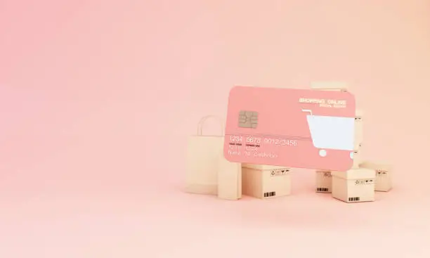 Photo of the concept of online shopping with shopping bag, cardboard box, box, shopping online design on template mock up pink Bank credit card isolate on pink background 3d rendering illustration