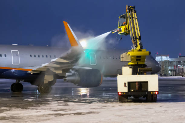 istock Ground deicing of a passenger airplane on the night airport apron 1387779310