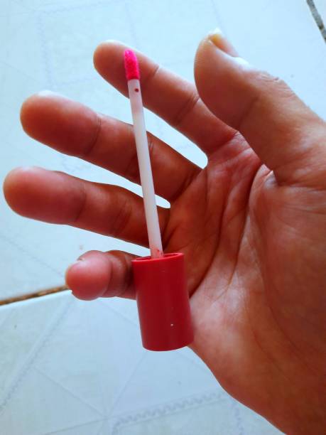 istock a person's hand holding a beauty device for lips 1387779350