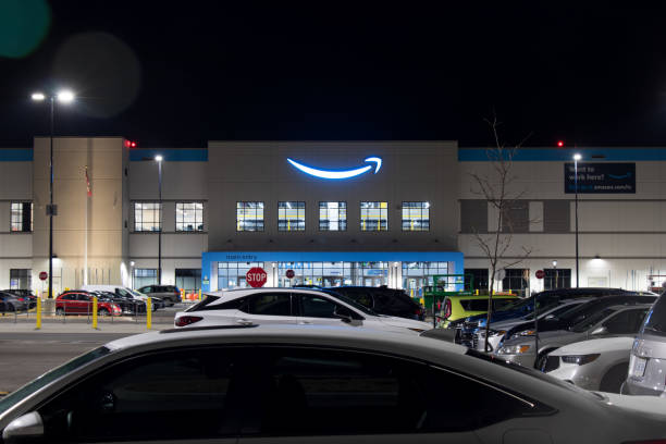 The Amazon logo shines brightly atop the front fulfillment center. stock photo