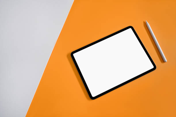 istock Flat lay mockup digital tablet with blank display and stylus pen on yellow background. 1387781957